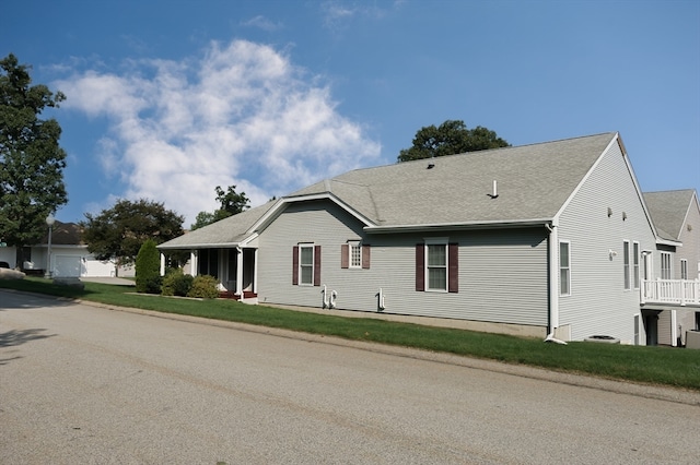 view of property exterior with a lawn and a garage