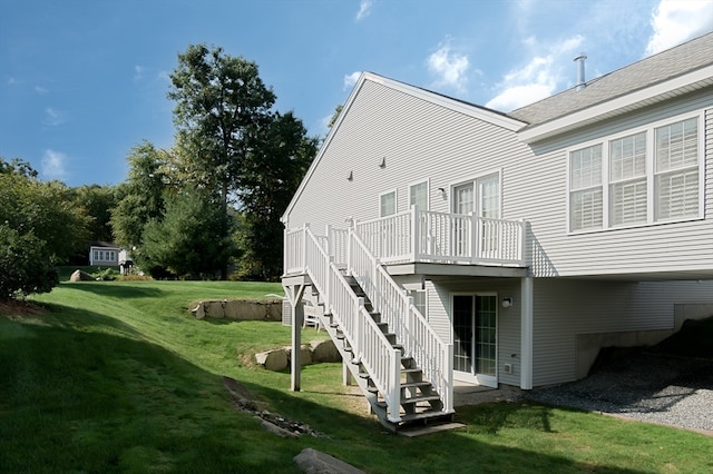 back of house with a yard and a deck