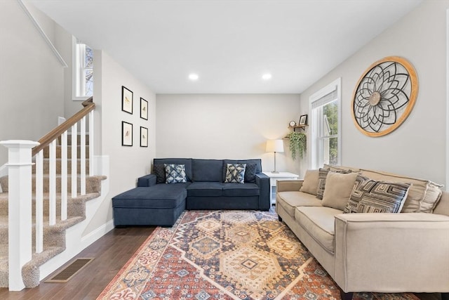 living room featuring visible vents, wood finished floors, baseboards, stairway, and recessed lighting