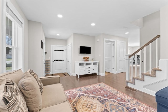 living room with baseboards, recessed lighting, wood finished floors, and stairway