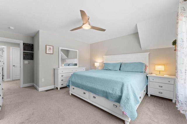 bedroom featuring baseboards, ceiling fan, and light carpet