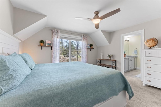bedroom featuring connected bathroom, a ceiling fan, light colored carpet, and lofted ceiling