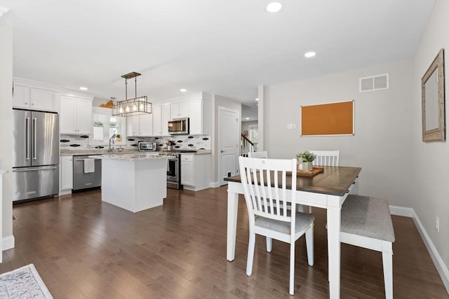 dining space with recessed lighting, baseboards, a toaster, visible vents, and dark wood-style floors