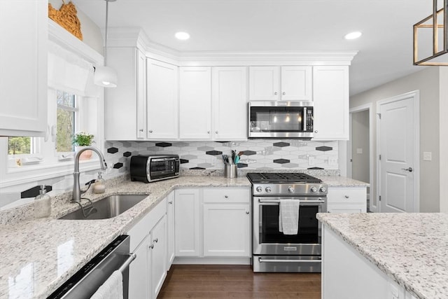 kitchen featuring a sink, appliances with stainless steel finishes, a toaster, and white cabinetry