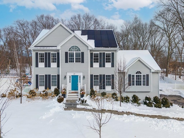 colonial-style house featuring solar panels