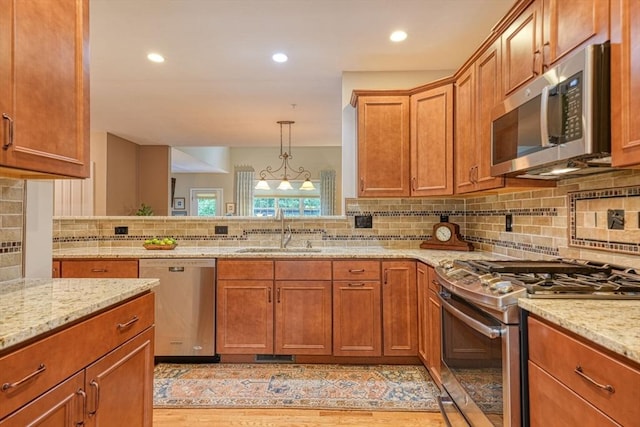 44 Stevens Rd Unit 44, Hudson, MA 01749 - kitchen featuring stainless steel appliances, tasteful backsplash, light stone counters, light wood-style floors, and recessed lighting