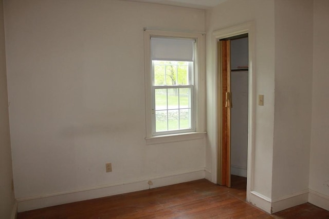 unfurnished room featuring wood finished floors and baseboards