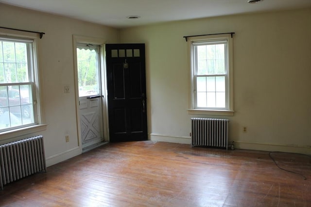 entryway featuring radiator heating unit and plenty of natural light