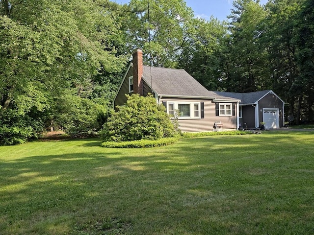 48 Sofia Rd, Stoughton, MA 02072 - view of property exterior with a lawn, a chimney, and a garage