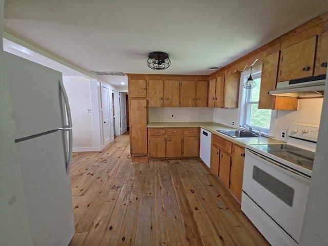 48 Sofia Rd, Stoughton, MA 02072 - kitchen with white appliances, under cabinet range hood, light wood-style floors, light countertops, and brown cabinetry
