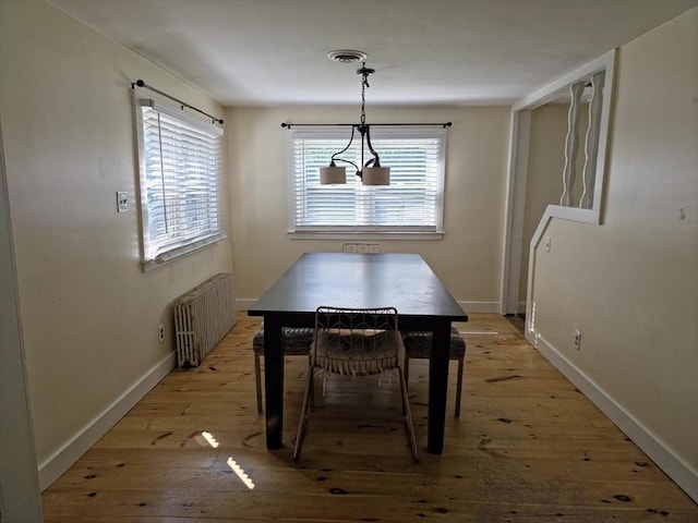 48 Sofia Rd, Stoughton, MA 02072 - dining space with radiator heating unit and light wood-style floors