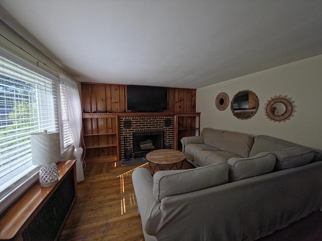 48 Sofia Rd, Stoughton, MA 02072 - living room with dark wood-style floors, a brick fireplace, and wooden walls