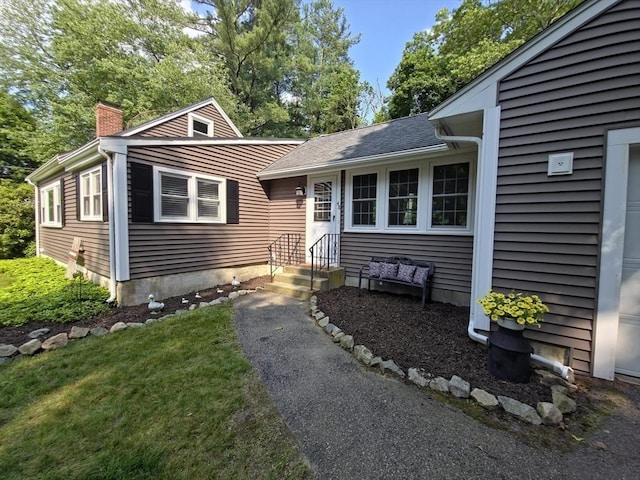 48 Sofia Rd, Stoughton, MA 02072 - view of front of home with a chimney and a shingled roof