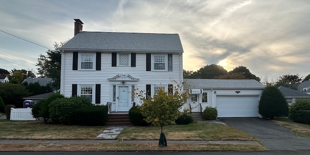 colonial inspired home featuring a garage