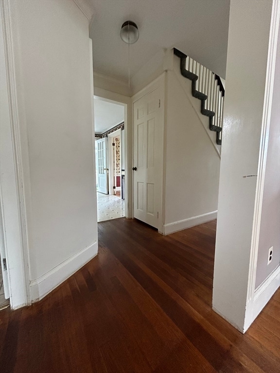 hallway with dark hardwood / wood-style flooring