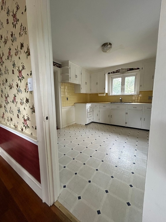 kitchen featuring sink and white cabinets