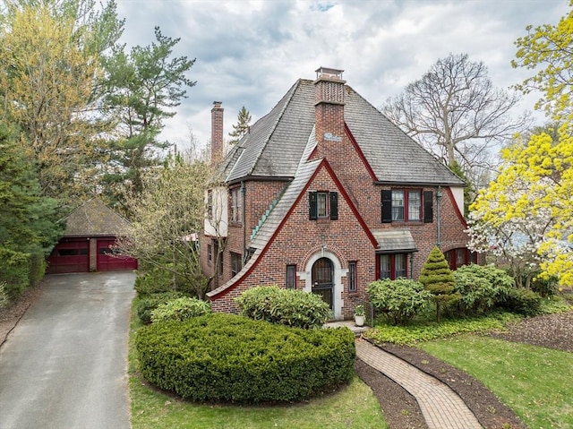 68 Ingersoll Grv, Springfield, MA 01109 - tudor home with a detached garage, brick siding, an outbuilding, and a chimney
