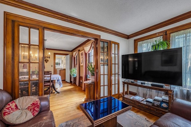 68 Ingersoll Grv, Springfield, MA 01109 - living room featuring crown molding, a textured ceiling, french doors, and wood finished floors