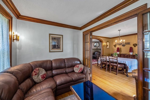 68 Ingersoll Grv, Springfield, MA 01109 - living area with visible vents, arched walkways, wood finished floors, a chandelier, and ornamental molding
