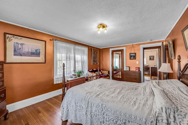 68 Ingersoll Grv, Springfield, MA 01109 - bedroom with baseboards, a textured ceiling, crown molding, and wood finished floors
