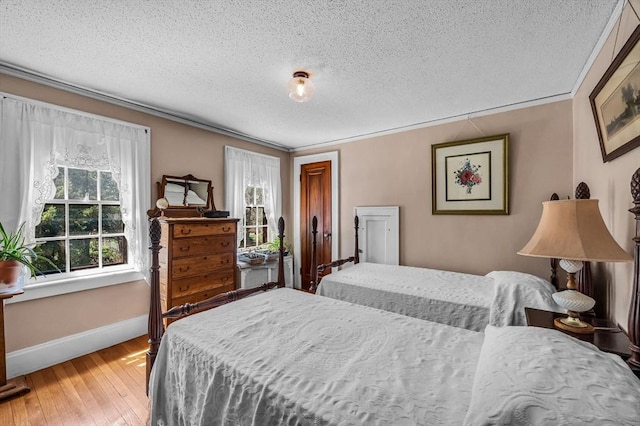 68 Ingersoll Grv, Springfield, MA 01109 - bedroom featuring crown molding, a textured ceiling, baseboards, and multiple windows