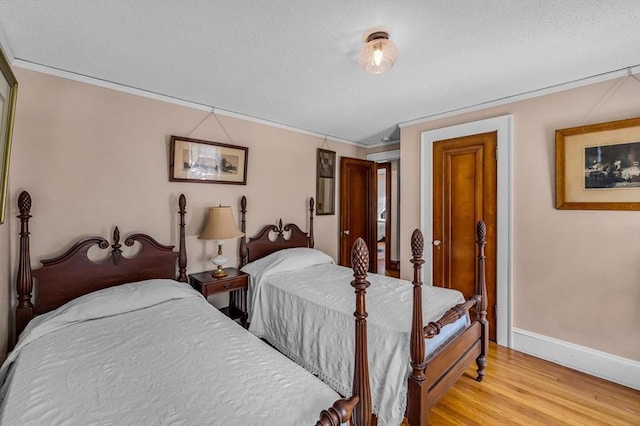 68 Ingersoll Grv, Springfield, MA 01109 - bedroom with baseboards, ornamental molding, a textured ceiling, and light wood-style flooring