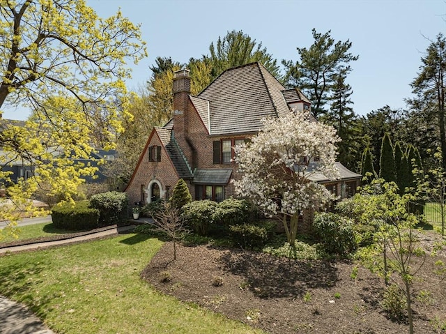 68 Ingersoll Grv, Springfield, MA 01109 - view of front facade featuring brick siding, a chimney, and a front yard