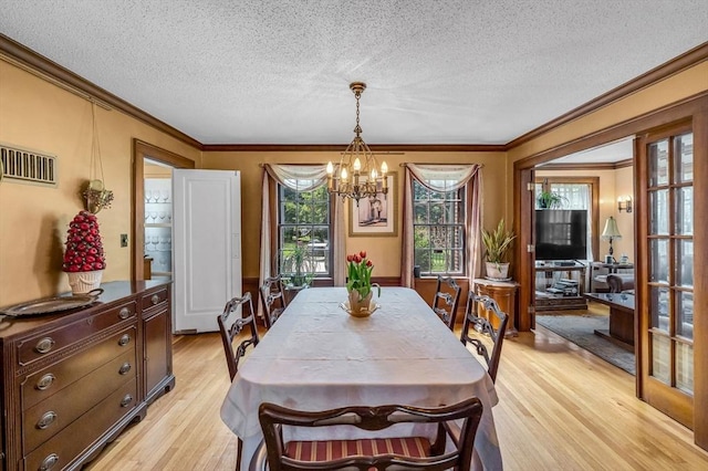 68 Ingersoll Grv, Springfield, MA 01109 - dining area with an inviting chandelier, light wood-style floors, crown molding, and visible vents