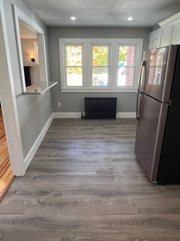 interior space featuring radiator heating unit and hardwood / wood-style flooring