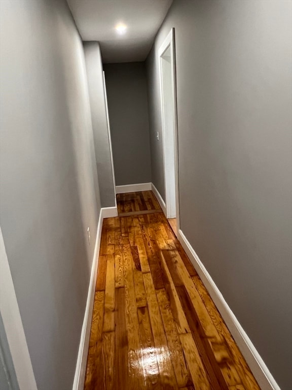 hall with wood-type flooring