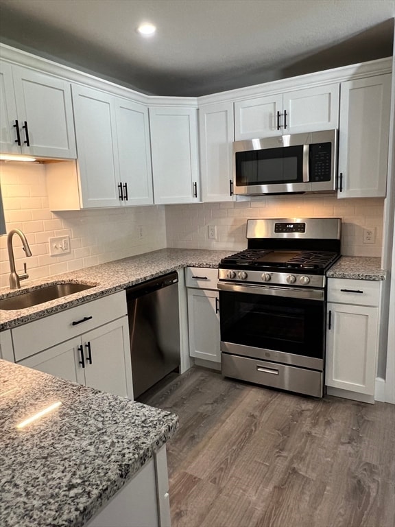 kitchen featuring white cabinets, appliances with stainless steel finishes, and sink