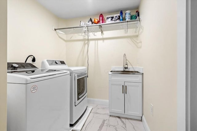 4 Cushing St, Hingham, MA 02043 - laundry room with light marble finish floors, washing machine and clothes dryer, baseboards, and cabinet space