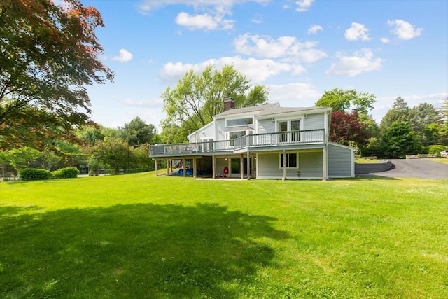 4 Cushing St, Hingham, MA 02043 - back of property featuring a wooden deck, a yard, a chimney, and stairway
