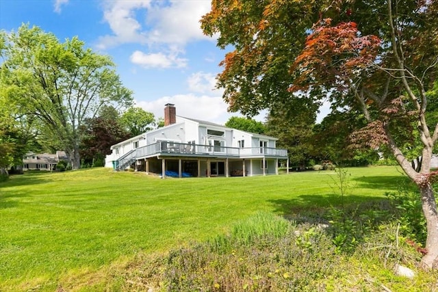 4 Cushing St, Hingham, MA 02043 - rear view of house featuring a wooden deck, a yard, and a chimney