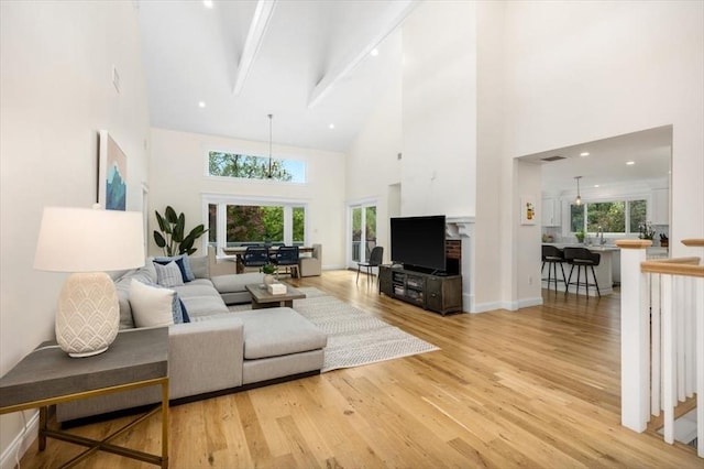 4 Cushing St, Hingham, MA 02043 - living area featuring high vaulted ceiling, light wood-type flooring, beamed ceiling, and baseboards