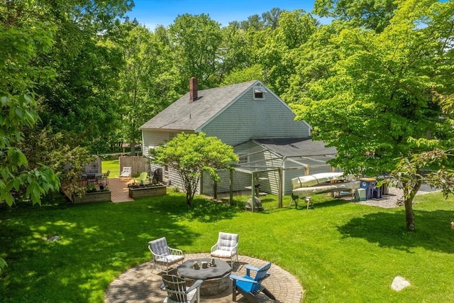 21 Norwell Ave, Norwell, MA 02061 - rear view of property featuring a fire pit, a yard, a chimney, a greenhouse, and a patio area