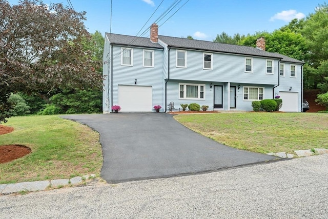 18 Buena Vis Unit 18, Franklin, MA 02038 - view of front facade featuring a chimney, a front lawn, and a garage