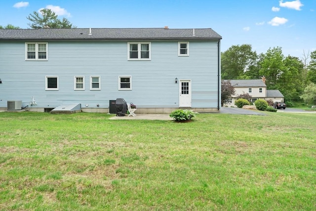 18 Buena Vis Unit 18, Franklin, MA 02038 - back of house featuring central AC and a yard
