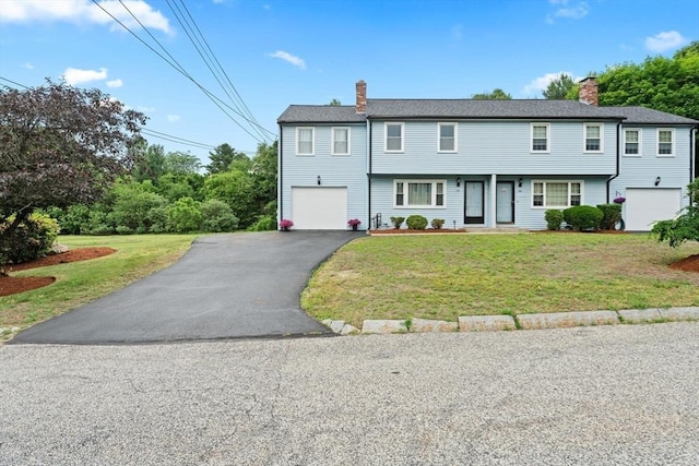18 Buena Vis Unit 18, Franklin, MA 02038 - view of property featuring a chimney, a garage, driveway, and a front lawn