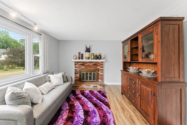18 Buena Vis Unit 18, Franklin, MA 02038 - living area featuring light wood-style flooring and a brick fireplace