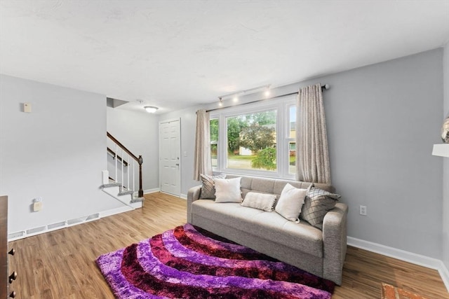 18 Buena Vis Unit 18, Franklin, MA 02038 - living room featuring stairs, wood finished floors, baseboards, and rail lighting