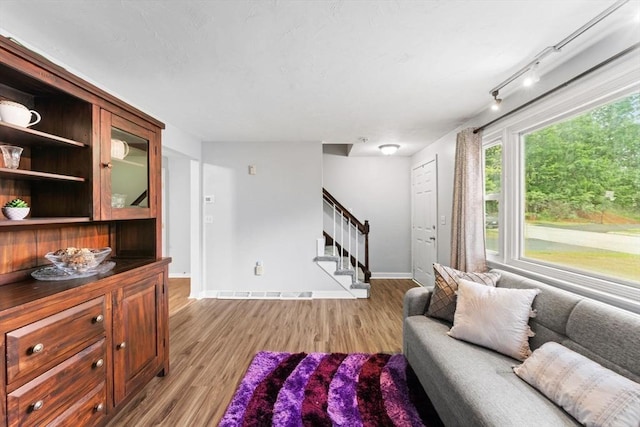18 Buena Vis Unit 18, Franklin, MA 02038 - living area featuring stairs, light wood-style floors, and baseboards