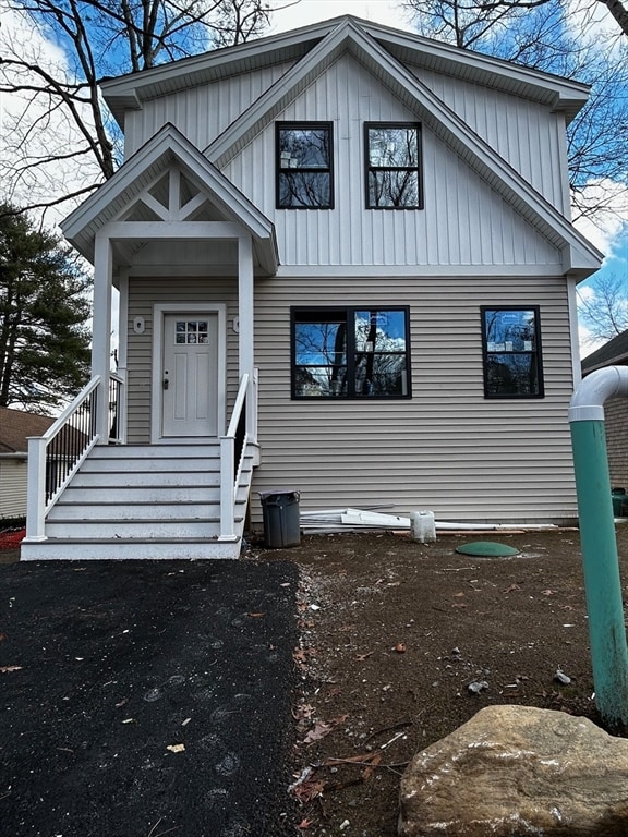 view of front facade featuring entry steps and board and batten siding