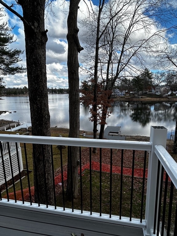 wooden terrace featuring a water view