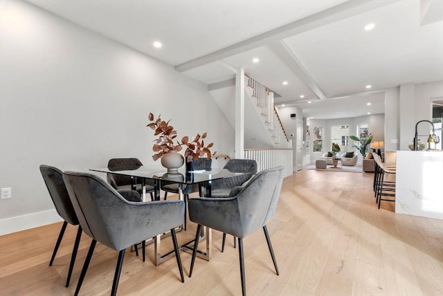 dining room featuring stairway, recessed lighting, baseboards, beamed ceiling, and light wood-style flooring