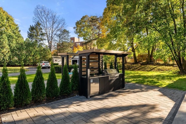 view of home's community featuring area for grilling, a yard, and a patio area
