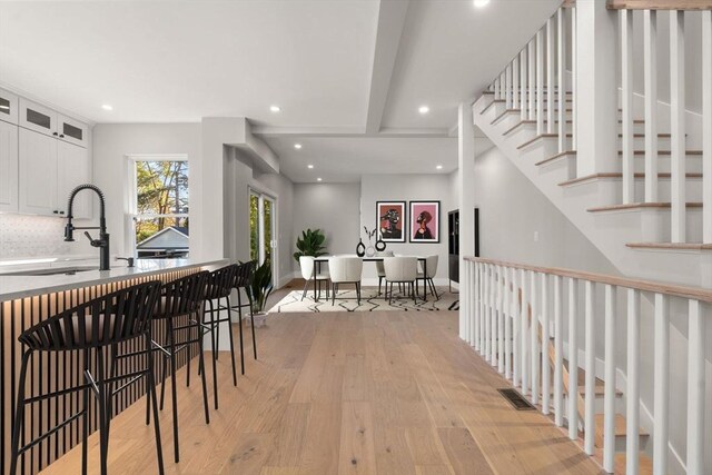 interior space with recessed lighting, baseboards, light wood-style floors, and visible vents