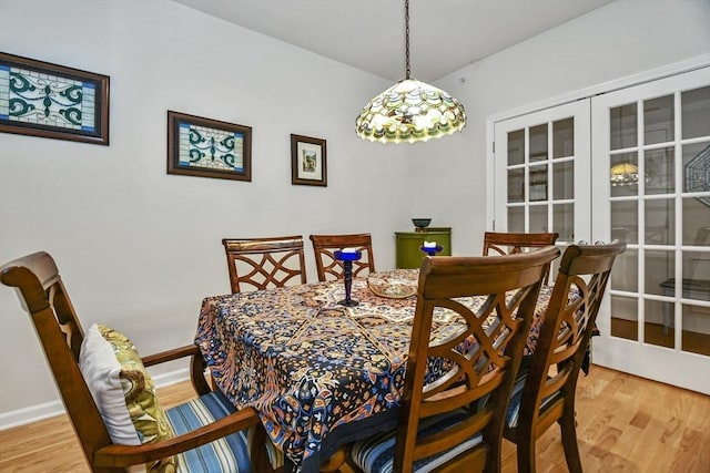 dining space featuring hardwood / wood-style floors and french doors