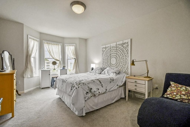 bedroom featuring light carpet