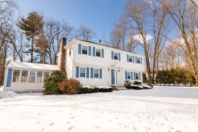 colonial house featuring a sunroom